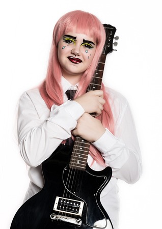 young girl with professional comic pop art make-up holding electric guitar. Funny cartoon or comic strip make-upの写真素材