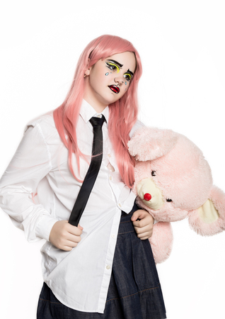 young girl with professional comic pop art make-up holding teddy bear. Funny cartoon or comic strip make-up.の写真素材
