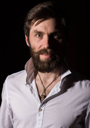 Portrait handsome bearded man, sexy guy on a dark backgroundの写真素材