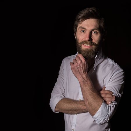 Portrait handsome bearded man, sexy guy on a dark background. free space for textの写真素材