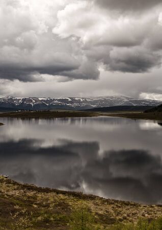 Mountain lake landscape with beautiful sky and storm cloudsの写真素材