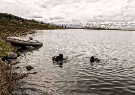 scuba diving in a mountain lake, practicing techniques for emergency rescuers. immersion in cold waterの写真素材