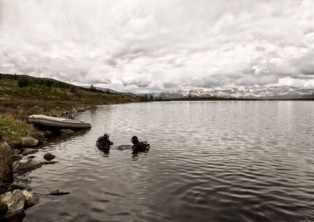 scuba diving in a mountain lake, practicing techniques for emergency rescuers. immersion in cold waterの写真素材