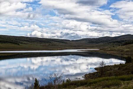 Mountain lake landscape with beautiful sky and cloudsの写真素材