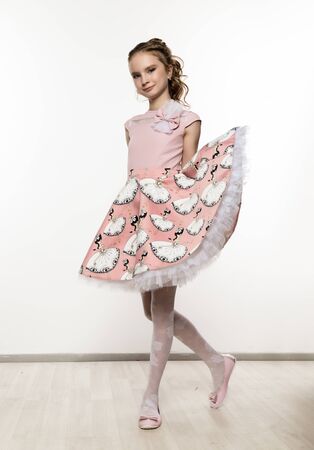 cute little girl in pink dress on white background. Children fashion, style concept.の写真素材