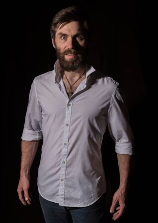 Portrait handsome bearded man, sexy guy on a dark backgroundの写真素材