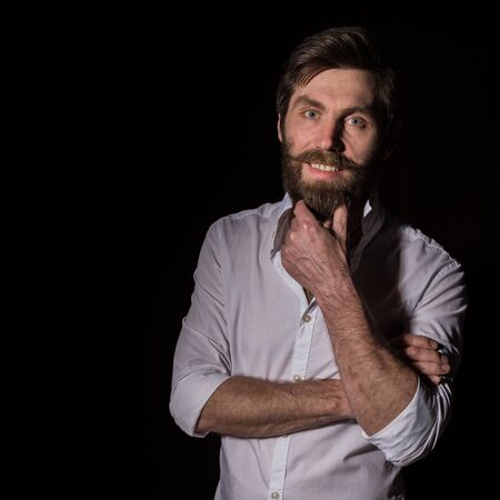 Portrait handsome bearded man, sexy guy on a dark background. free space for textの写真素材