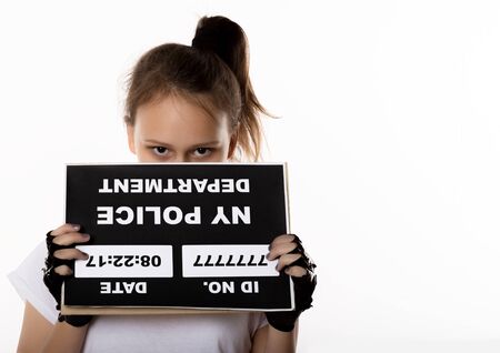 Sad girl prisoner, difficult children, social tension. Criminal Mug Shots. free space for textの写真素材