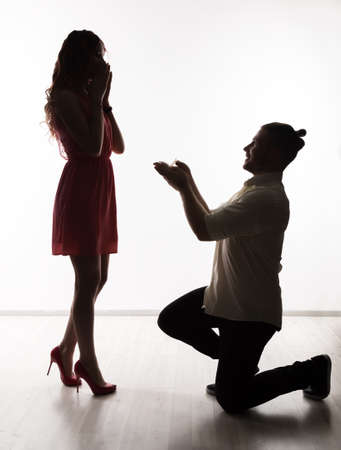 Lovely beautiful couple standing and hugging in a studio. Intimate moments romantic loversの写真素材
