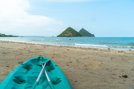 Kayak on Beach In Summer Sunny Day. Colorful kayaks on a beach. Kayaks stand on sand beach and sea blue sky with island background.の写真素材