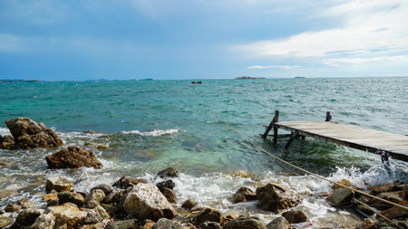 wooden bridge juts out into of the sea. Wooden bridge on the way to the harbor. Beautiful landscape....
