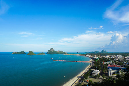 Aerial view of Prachuap Khiri Khan harbor southern of Thailand. Beautiful blue sea and green island with city and beach at Prachuap bay.の写真素材