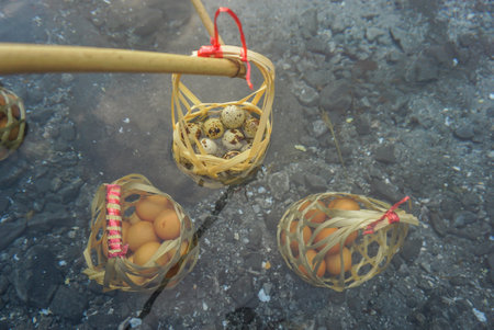 Boiled eggs in natural hot springs. Chicken eggs in basket of tourists boiled in mineral and natural hot water at Chae Son National Park Lampang, Thailand..の写真素材