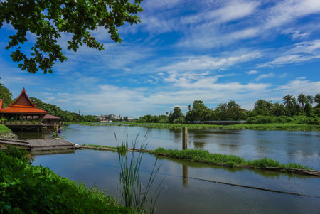 Wooden pier on the river at rural area local of Thailand. Floating Village on the water of a river in Thailand, colorful reflection on the water, pier and houses.の写真素材