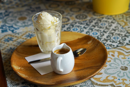 Affogato italian ice cream served in dish on table top view of arabic breakfast. Vanilla ice-cream served with coffee in a modern cafe.の写真素材