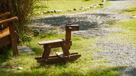 A wooden toy horse in the green grass garden.の写真素材