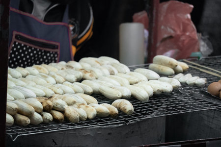 Roasted banana or Grilled banana for sale on the street of Thailand. Thai street food grilled bananas and sweet potato.の写真素材