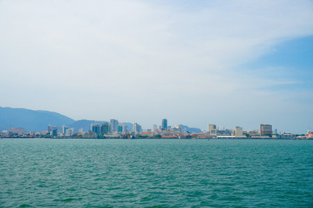 Moored merchant ship in front of the city Butterworth also known as Bagan on the mainland of the Malaysian state of Penangの写真素材