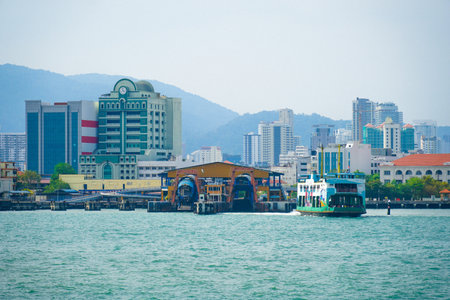 PENANG, MALAYSIA Ferry carrying passengers cruising between Malaysia mainland and Penang island. It is one of Penang tourism heritages.の写真素材