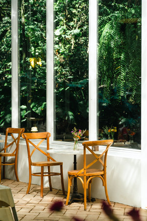 wooden terrace with garden furniture surrounded by greenery, wood sofa and table made of metal and...