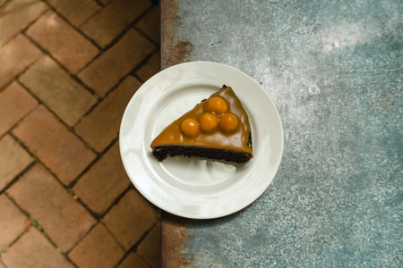 Caramel Macadamia Chocolate Cake. Closeup shot of little sweet decorative cake. Free space for text....