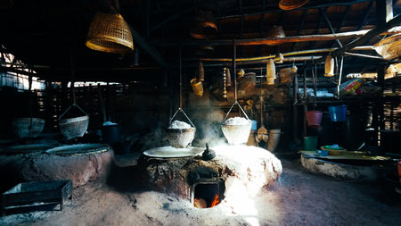 Selective Salt In Basket Is Hungover Stove Is Product Of Salty Water From Underground In Mountains,Nan ,Thailand. Boiling rock salt, traditional salt making. Rock salt is in a basket hanging above a pan for boiling brine is placed in a salt producing communityの写真素材