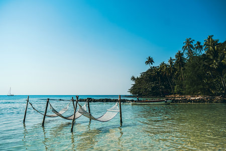 Romantic cozy hammock at tropical paradise ocean beach in bright sunny summer day. Summer beach...