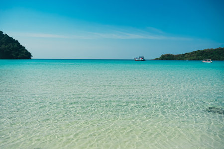 Nature tropical beach sea. Beautiful beach blue sea water at Koh Kood, Thailand. Turquoise Blue beach with white soft sand and lush green trees. Tropical beach with blue sky and white clouds. Summer vacation and holiday business travel concept.の写真素材