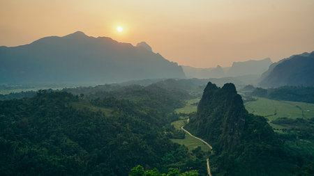 Stunning view of some tourists taking pictures at the beautiful panorama from the Nam Xay viewpoint in Vang Vieng, Laos.の写真素材