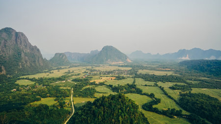 Stunning view of some tourists taking pictures at the beautiful panorama from the Nam Xay viewpoint in Vang Vieng, Laos.の写真素材