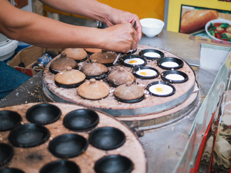 Banh can - The mini pancakes with rice flour, egg, onion leaves with soft selective focus, and...