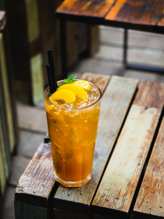 Refreshing iced tea with ripe peaches. Delicious peach iced tea Cuba Libre or Long Island iced tea cocktail in glasses. Homemade refreshing summer drink recipe. Refreshing peach lemonade. Summer cold drinkの写真素材