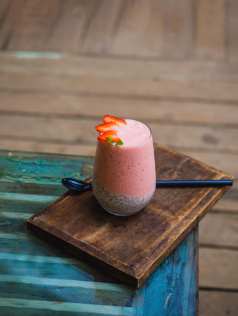 Strawberry smoothie. Vegan smoothie or milkshake from strawberry, and mint on wooden table background.の写真素材