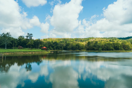Tranquil summer landscape of a pristine lake with clear blue skies and fluffy white clouds. Adventures Camping tourism and tent. Beautiful lake with tent in place for camping at Jedkod Pongkonsao, Saraburi, Thailand.の写真素材