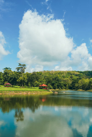 Tranquil summer landscape of a pristine lake with clear blue skies and fluffy white clouds. Adventures Camping tourism and tent. Beautiful lake with tent in place for camping at Jedkod Pongkonsao, Saraburi, Thailand.の写真素材