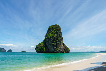The beautiful Railay Beach and Krabi, Thailand. Railay Beach Krabi Thailand, the tropical beach of Railay Krabi, Panoramic view of idyllic Railay Beach in Thailand with a traditional long boat and a cloudy skyの写真素材