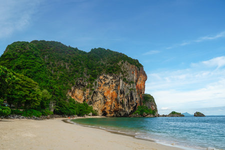 The beautiful Railay Beach and Krabi, Thailand. Railay Beach Krabi Thailand, the tropical beach of Railay Krabi, Panoramic view of idyllic Railay Beach in Thailand with a traditional long boat and a cloudy skyの写真素材