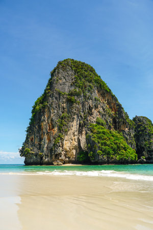 The beautiful Railay Beach and Krabi, Thailand. Railay Beach Krabi Thailand, the tropical beach of Railay Krabi, Panoramic view of idyllic Railay Beach in Thailand with a traditional long boat and a cloudy skyの写真素材