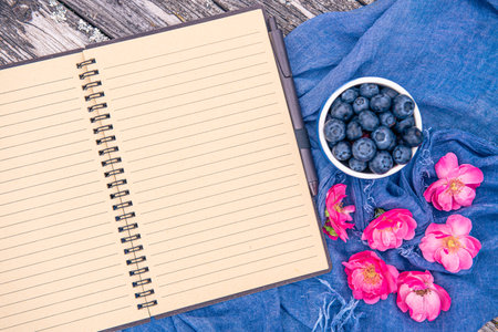 Blueberries and open notebook. Top view with copy spaceの写真素材