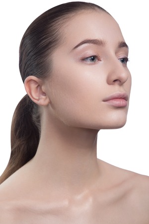 Portrait of beautiful young brunette woman with clean face. Beauty spa model girl with perfect fresh clean skin. Looking at camera and smiling. Youth and skin care concept.の写真素材