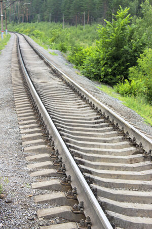 Railroad tracks stretching into the distance for the turnの写真素材