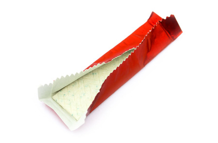 Chewing gum in red shiny wrapper isolated on whiteの写真素材