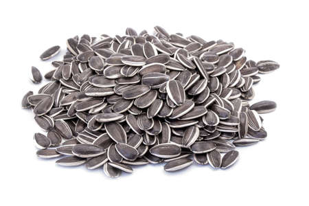 A handful of sunflower seeds closeup isolated on whiteの写真素材