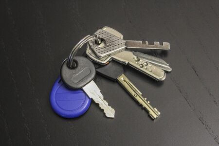 Bunch of keys on a black wooden table