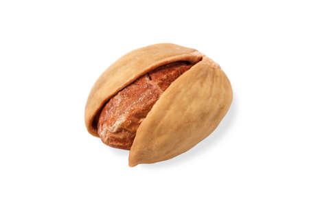 One salted pistachio close up isolated on white background