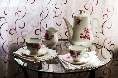 Tea set for two on a small glass tableの写真素材