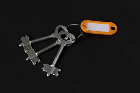 Set of apartment keys isolated on black