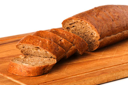 Sliced rye baguette on a wooden board