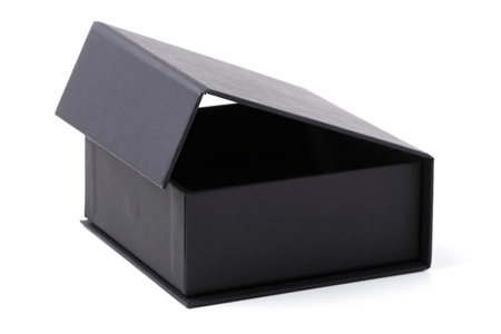 Black gift cardboard box with magnetic lid isolated on whiteの写真素材