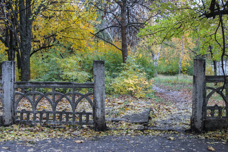 Entrance to an abandoned park in autumnの写真素材
